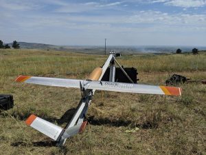 Figure 1: The NightFOX remote sensing UAS system is loaded onto the launcher for sampling a prescribed burn in Boulder County